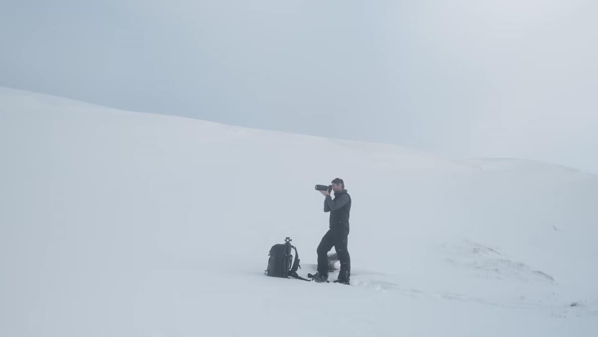 Telephoto compression of distant cliffs and snowy ridgeline