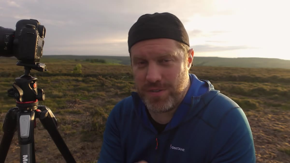 Adam preparing to use a drone above the moorland landscape