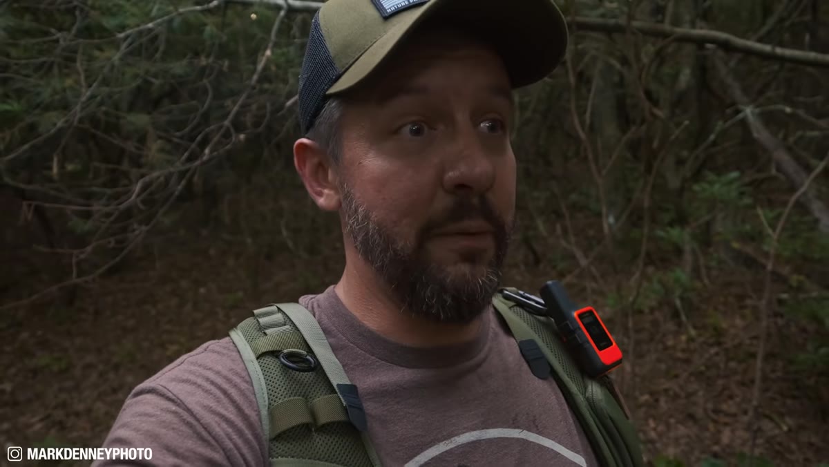 Photographer hiking toward unfamiliar Blue Ridge Mountain location at dusk