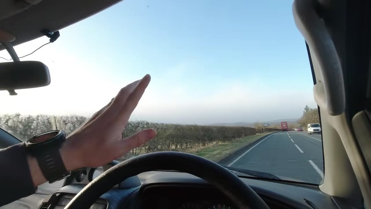 Storm clouds visible on horizon through windshield