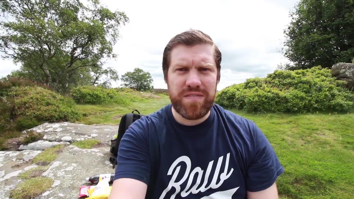 Photographer eating lunch alone on rock edge away from visitor centre