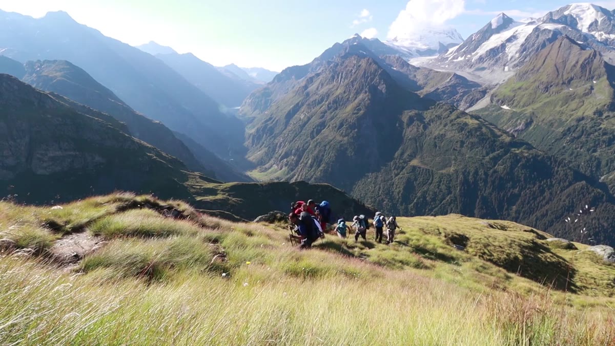 Group trekking through alpine terrain in the final stretch of the hike