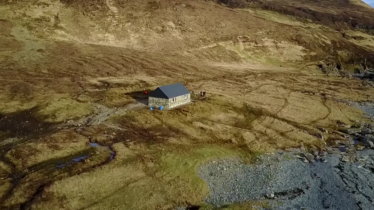 Thomas describing the bothy&rsquo;s practical uses for cooking and gear maintenance