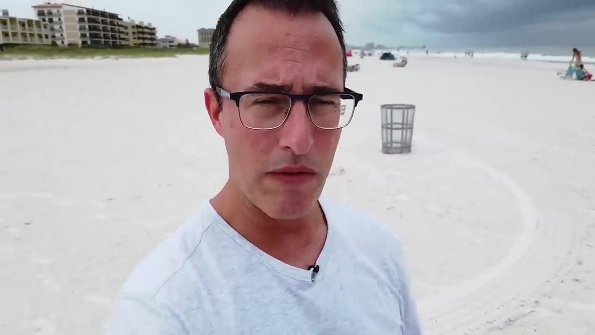 Camera positioned low showing foreground beach and pier distance