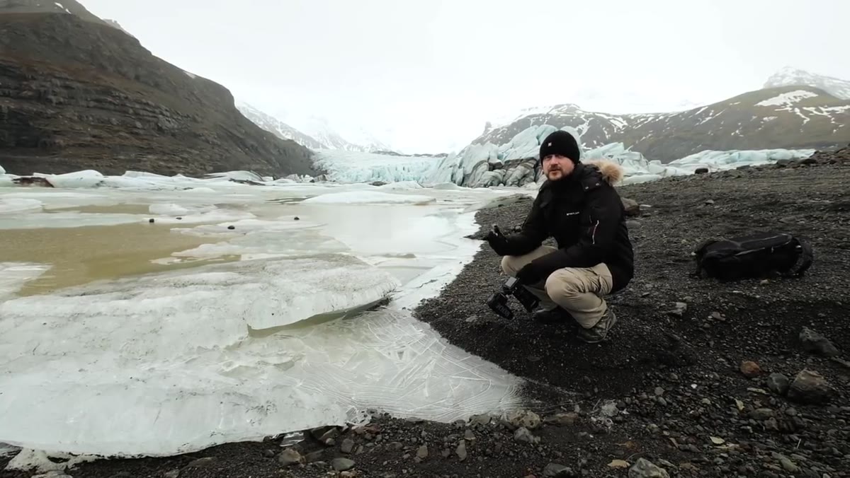 Danson explaining sunset light potential at the glacier location
