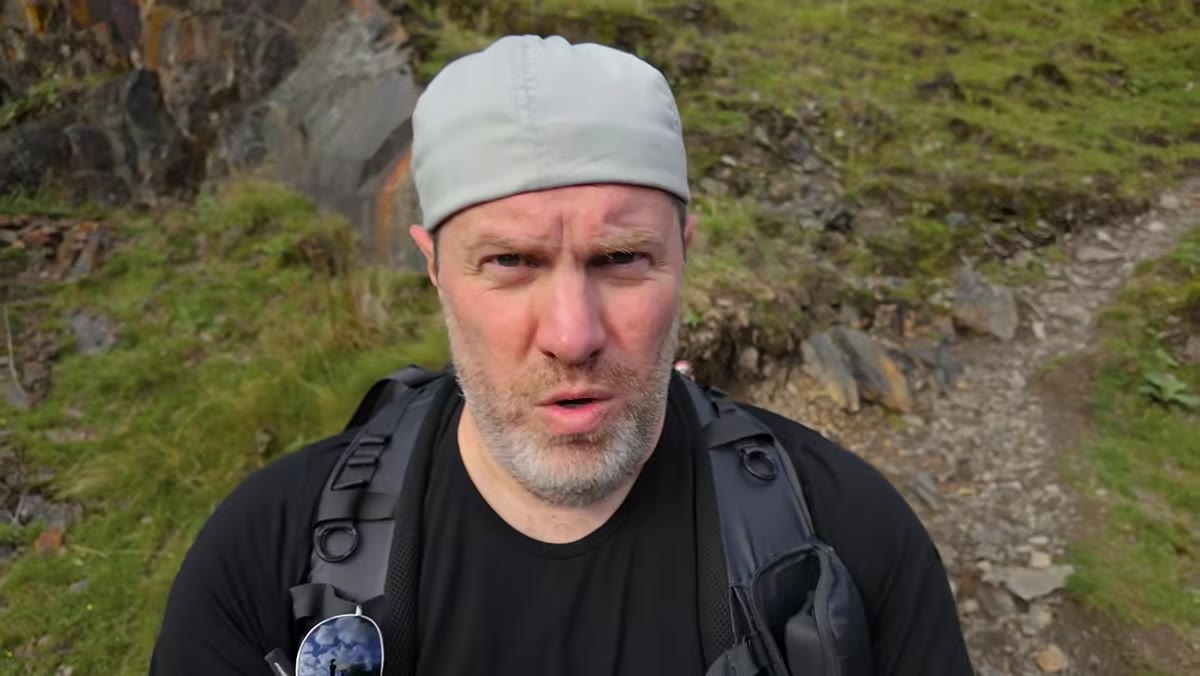 Steep rocky descent toward the base of the waterfall