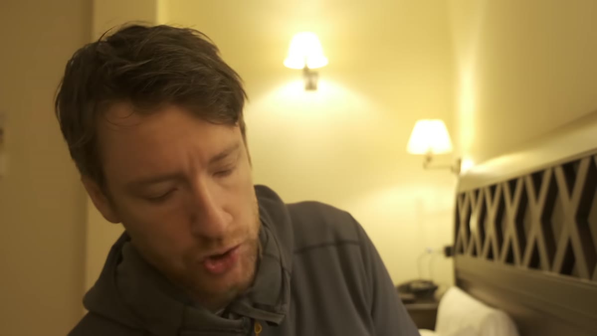 Heaton in the hotel room discussing the supplements and routines he uses on long trips